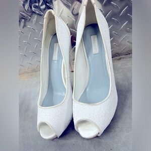 White peep toe heals with textured fabric